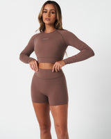 Complete look featuring brown long sleeve women’s crop top and shorts, perfect for workouts.
