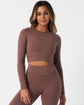 Women’s long sleeve workout crop top in brown, featuring compressive fit and soft 4-way stretch fabric.