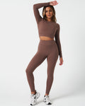 Full body shot of brown Force Crop top, styled with high-waisted leggings for a sleek gym outfit.