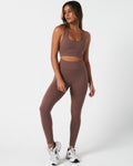 Full body outfit view of the Force Bra and matching high-waisted leggings in brown.