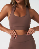 Close up of Force shorts in brown, showcasing stitching and soft performance fabric.