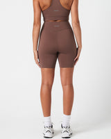 Back view of women’s Force 6.5" shorts  in brown highlighting squat-proof stretch and logo placement.