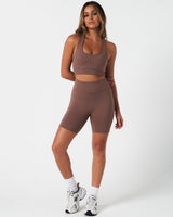 Complete activewear outfit showing the Force Bra with 4-way stretch shorts in a brown.