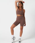 Full body outfit view of the Force Bra and matching high-waisted shorts in brown.