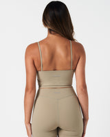 Rear profile of women’s Force Tank in light green, featuring center-back reflective branding.