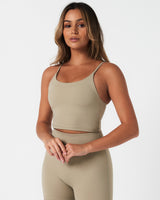 Left angle of Force Tank in light green with sculpted compression fit and second-skin stretch fabric.