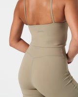 Close-up of LYFTLYFE reflective logo centered at the back of the light green Force Tank.