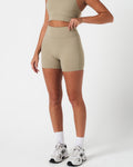 Compressive 4-inch light green biker shorts by LYFTLYFE, shown from the left side with sculpted shape and high stretch.