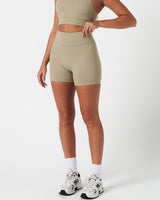 Compressive 4-inch light green biker shorts by LYFTLYFE, shown from the left side with sculpted shape and high stretch.
