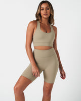 Complete activewear outfit showing the Force Bra with 4-way stretch shorts in light green.