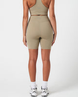 Back view of women’s Force 6.5" shorts  in light green highlighting squat-proof stretch and logo placement.