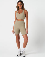 Full body outfit view of the Force Bra and matching high-waisted shorts in light green.