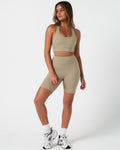 Full body outfit view of the Force Bra and matching high-waisted shorts in light green.