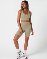 Full body outfit view of the Force Bra and matching high-waisted shorts in light green.