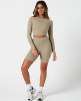 Full body view of women’s Force Long Sleeve Crop paired with matching green shorts.