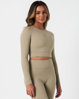 Right side view of Force Long Sleeve Crop in light green, showing sculpting fit and seamless construction.