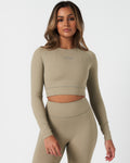 Women’s long sleeve workout crop top in light green, featuring compressive fit and soft 4-way stretch fabric.