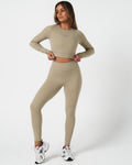 Complete look featuring light green long sleeve women’s crop top and leggings, perfect for workouts.