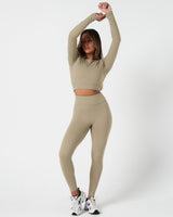 Full body view of women’s Force Long Sleeve Crop paired with matching light green leggings.
