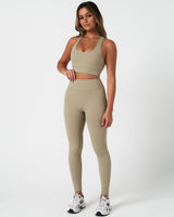 Full body shot of model in Force leggings and matching top in light green, highlighting full fit.