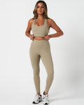 Complete activewear outfit showing the Force Bra with 4-way stretch leggings in a coordinated neutral tone.