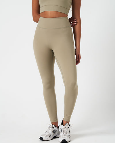 Front-facing image of the Force leggings in light green, highlighting no front seam and smooth silhouette.