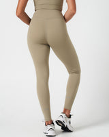 Back profile of high-rise Force leggings in light green, designed for sweat-wicking performance.