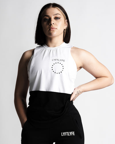 Women’s two-panel sleeveless shirt, white on top and black on the bottom, with anti-odor performance fabric, and Lyftlyfe logo on the chest.