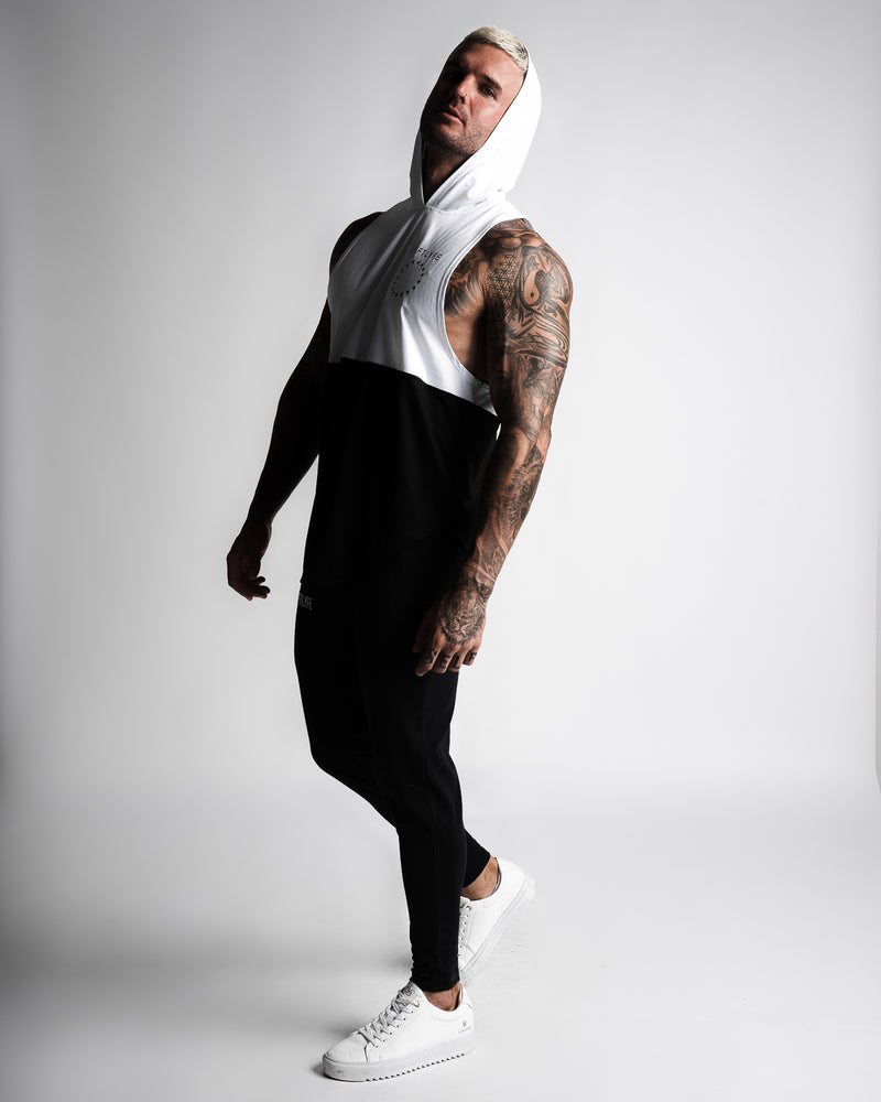 Men's sleeveless hoodie designed in two panels. The first panel is white, including the hood. The second bottom panel is in black. 