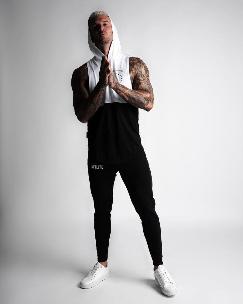 Men's sleeveless hoodie designed in two panels. The first panel is white, including the hood. The second bottom panel is in black. 