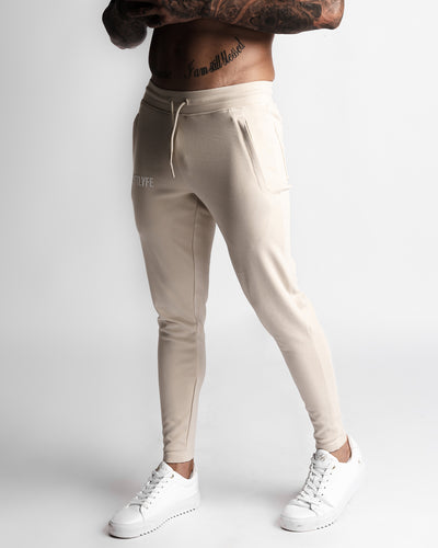 Men’s beige joggers left side angle highlighting comfort stretch and silhouette. 