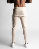 Back view of Function joggers in beige showing dual rear pockets and clean lines. 