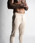 Close-up of LYFTLYFE logo and waistband on beige Function joggers. 