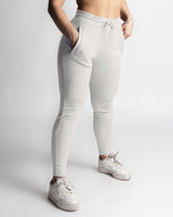 Right side view of light grey joggers showing contour fit and high-rise waistband. 