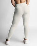 Rear view of women's joggers in light grey showing contour fit and high-rise waistband. 