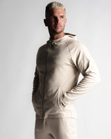 Left side view of Men's slim-fit hoodie in sand color with zipper and ergonomic seamlines.