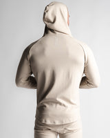 Men's athletic hoodie in sand color, back profile highlighting muscle-contour fit.