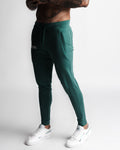 Right side view of men’s Function joggers in dark green with hidden zipper pocket detail. 