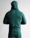 Men's athletic hoodie in green, back profile highlighting muscle-contour fit.