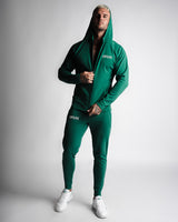 Full-body athletic look in Function hoodie and joggers zipped up in matching green. 