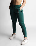 Left side angle of LYFTLYFE React joggers in green showing tapered leg and pocket detail. 