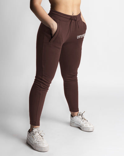Women’s dark brown joggers front view with high waist and white LYFTLYFE logo. 