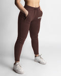 Dark brown joggers right side view showing snug waistband and ankle taper. 