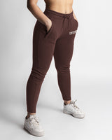 Dark brown joggers right side view showing snug waistband and ankle taper. 