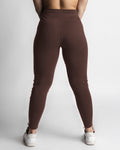 Women’s joggers in dark brown, back profile with sculpted athletic shaping. 