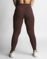Women’s joggers in dark brown, back profile with sculpted athletic shaping. 