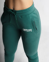 LYFTLYFE branding and front pocket detail on high-waisted joggers in green.