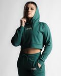 Cropped side view of women's hoodie in green showing relaxed fit and stretch fabric.