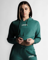 Cropped front view of LYFTLYFE React hoodie in green showing logo and high-waist jogger pairing.