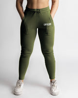Full front view of sculpted fit green joggers with tapered ankle and logo. 